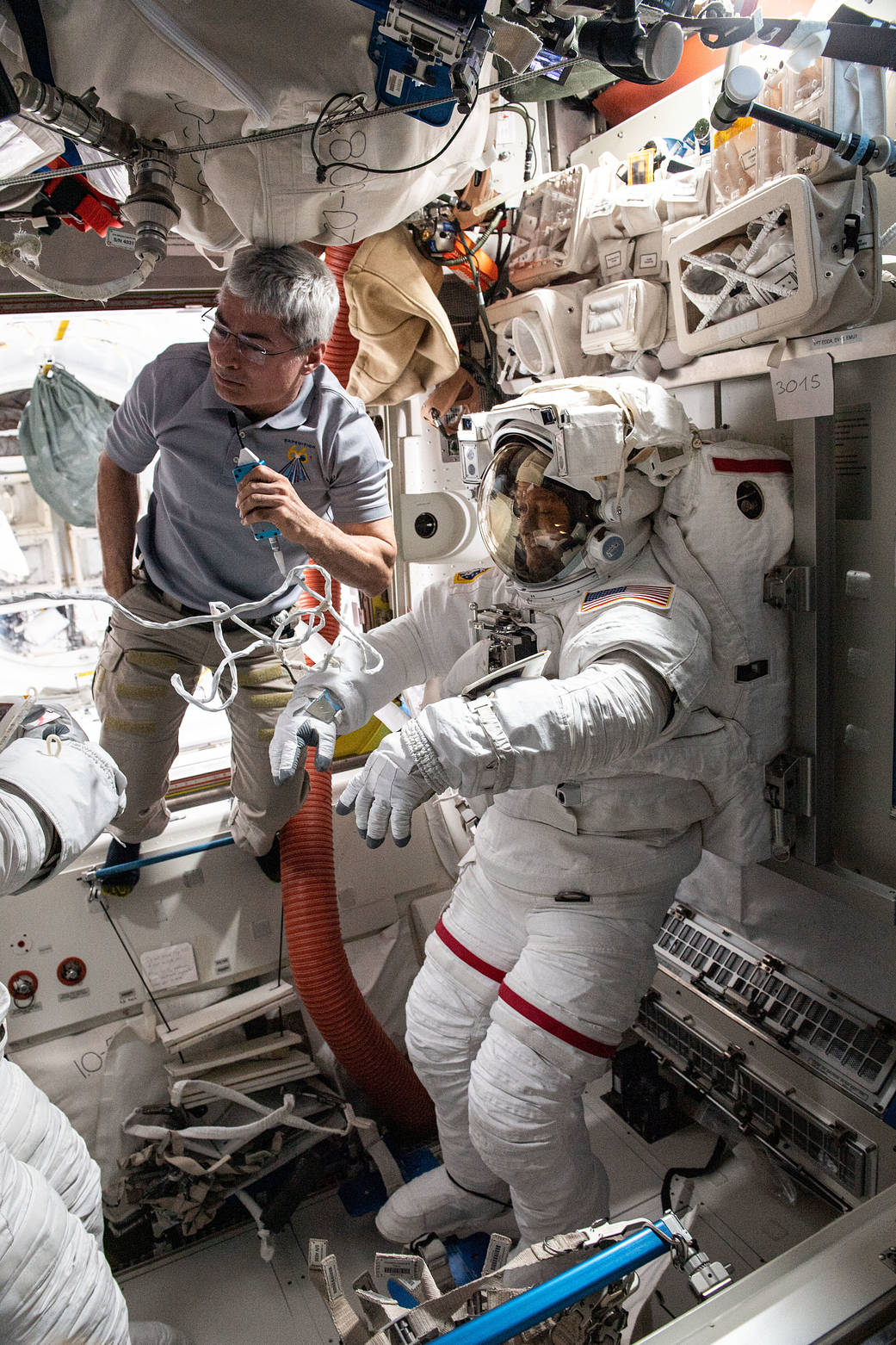 Astronaut Mark Vande Hei assists spacewalker Thomas Marshburn