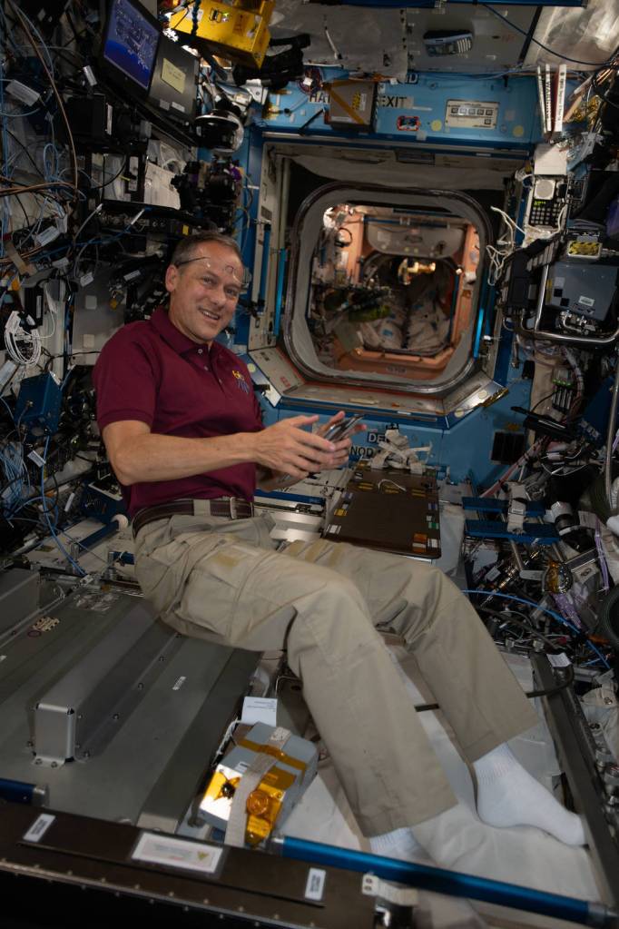 Astronaut Thomas Marshburn collects potable water samples