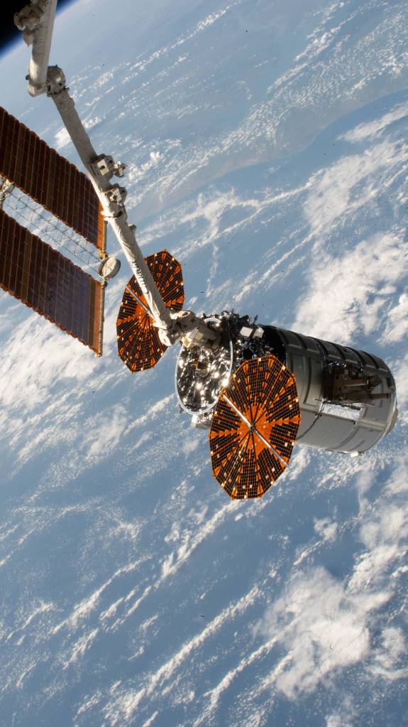 The Cygnus space freighter in the grip of the Canadarm2