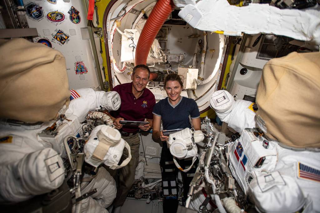 Astronauts Thomas Marshburn and Kayla Barron work on U.S. spacesuits