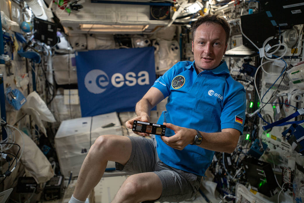Astronaut Matthias Maurer shows off the Touching Surfaces experiment