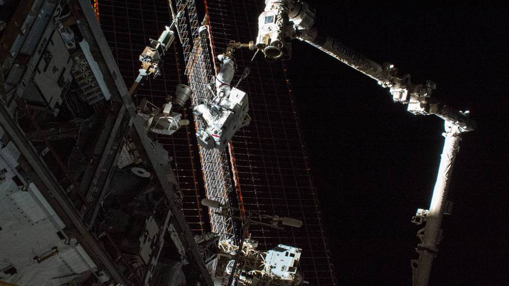 NASA spacewalker Thomas Marshburn rides the Canadarm2 robotic arm