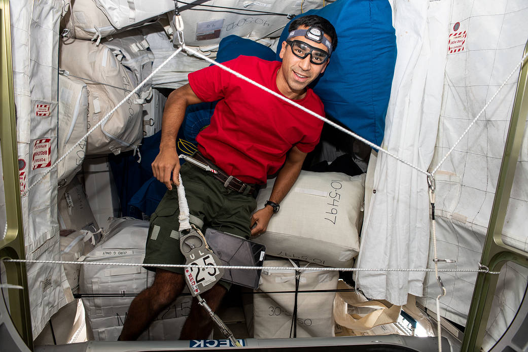 Astronaut Raja Chari organizes storage space on the station