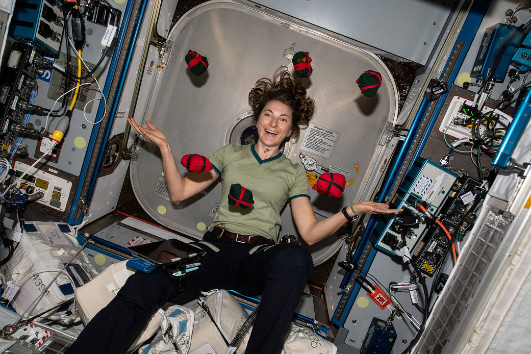 NASA astronaut Kayla Barron seemingly juggles Christmas presents