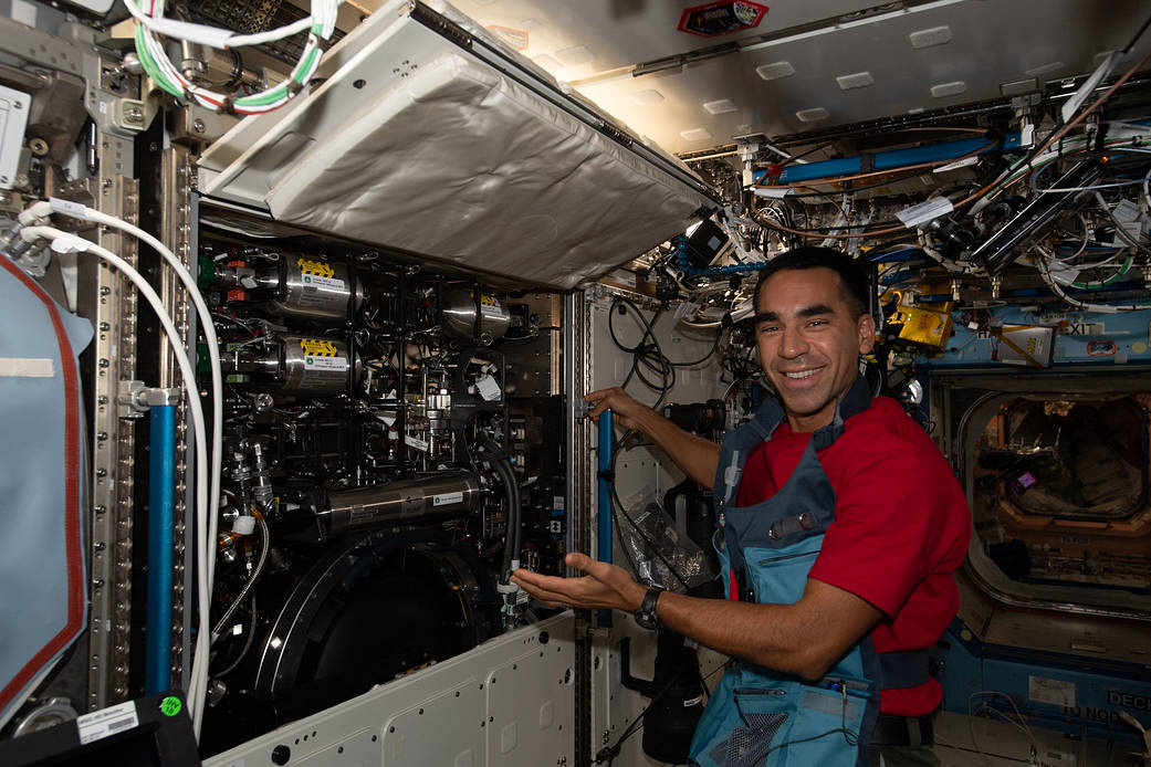 Astronaut Raja Chari displays the half-opened Combustion Integrated Rack