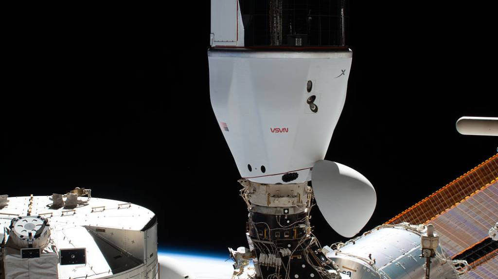 The SpaceX Cargo Dragon is pictured docked to the space station