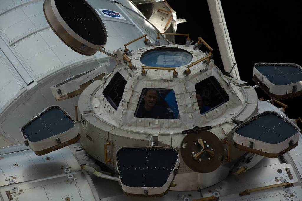 Astronaut Thomas Marshburn peers out from a window inside the cupola