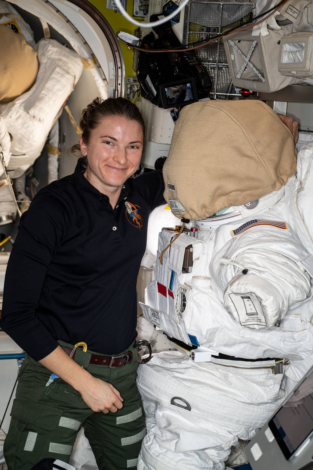 Astronaut Kayla Barron works on a U.S. spacesuit