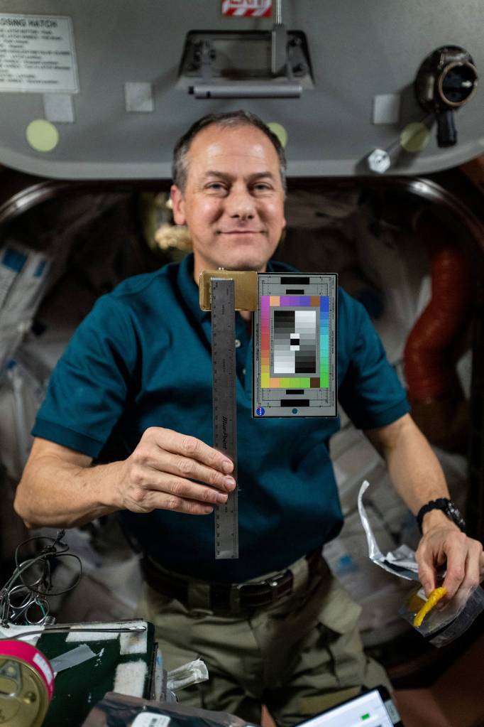 Astronaut Thomas Marshburn poses with gear for the SQuARES study