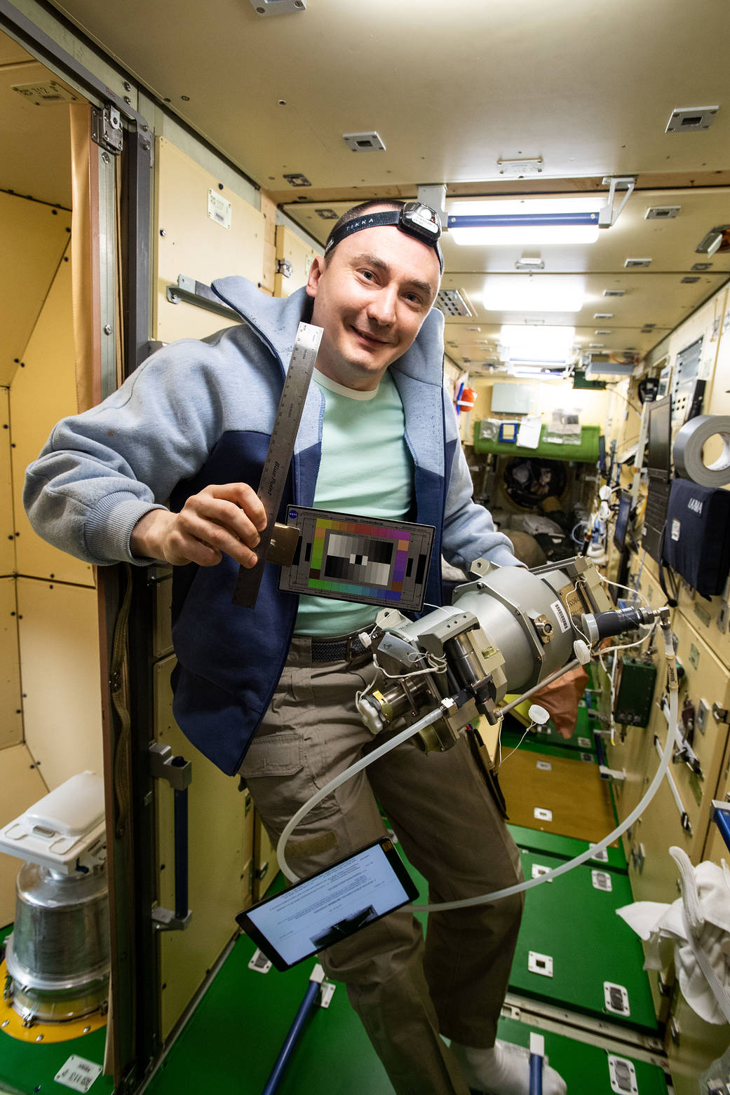 Cosmonaut Pyotr Dubrov poses with gear for the SQuARES study