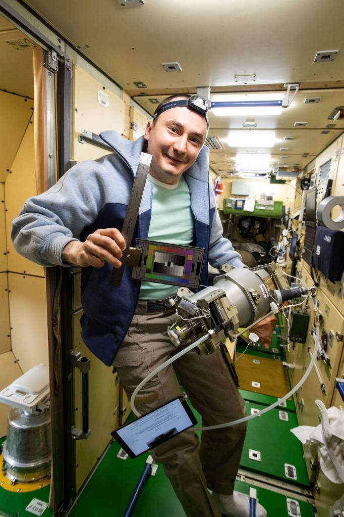 Cosmonaut Pyotr Dubrov poses with gear for the SQuARES study