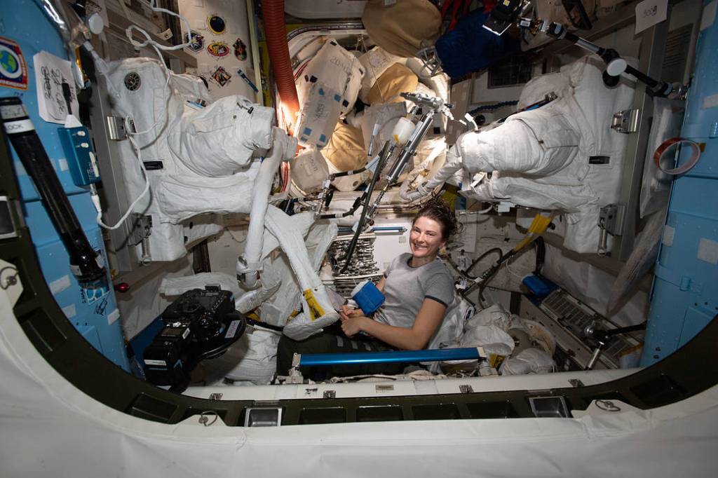 NASA astronaut Kayla Barron works on a pair of U.S. spacesuits