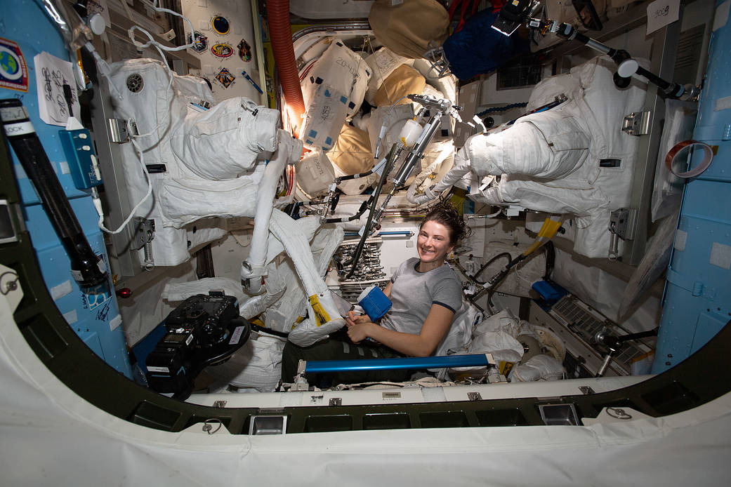 NASA astronaut Kayla Barron works on a pair of U.S. spacesuits