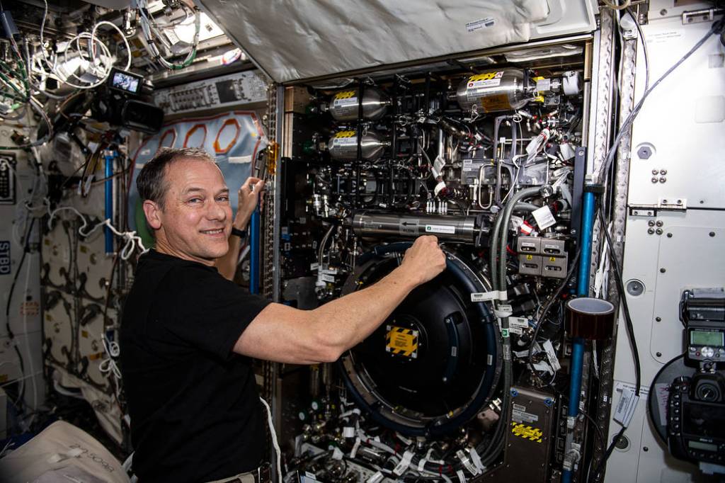 Astronaut Thomas Marshburn configures the Combustion Integrated Rack