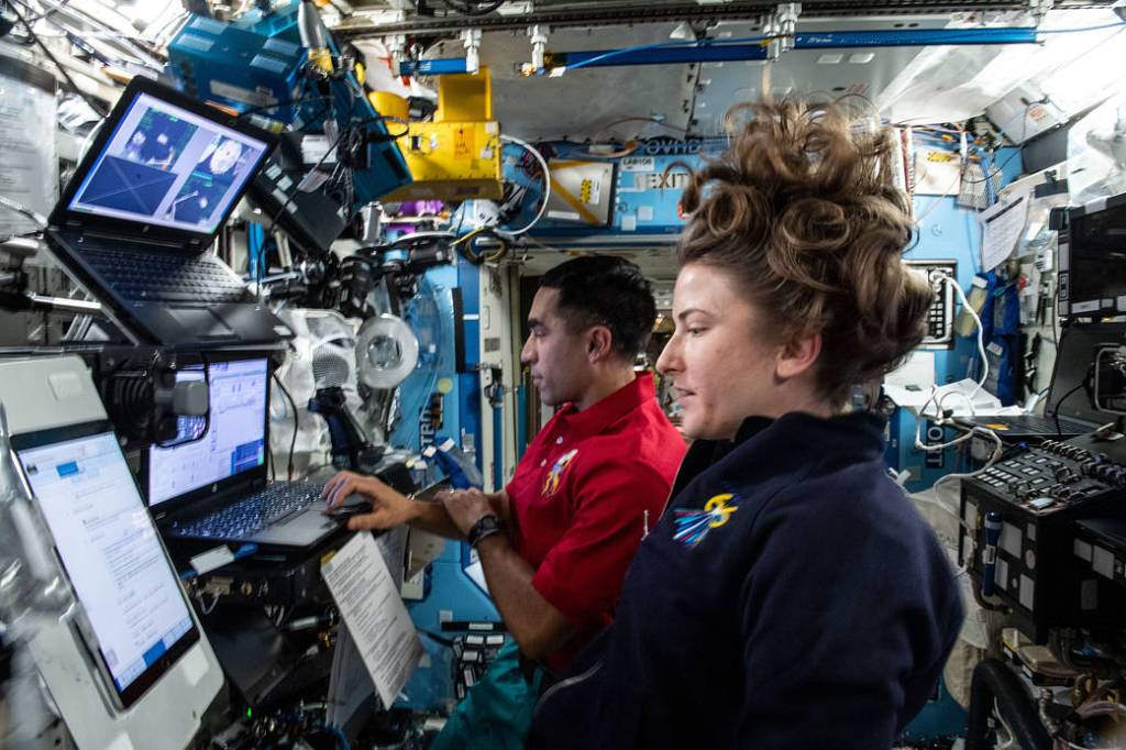 Astronauts Raja Chari and Kayla Barron train on the robotics workstation