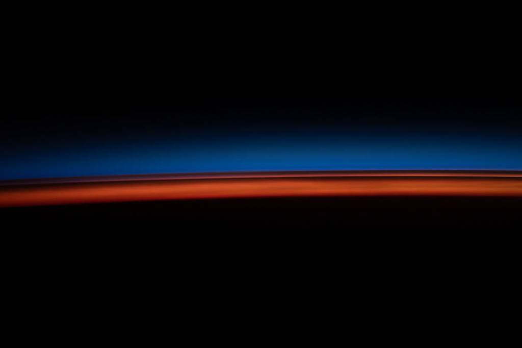 The first rays of an orbital sunrise illuminate Earth’s atmosphere