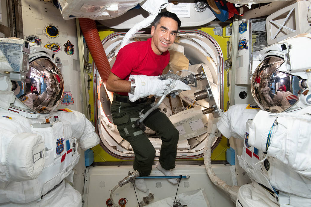 Astronaut Raja Chari tests using tools while wearing a spacesuit glove