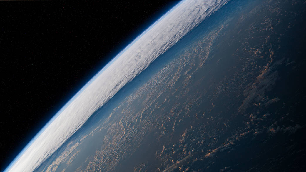 The station orbits above a cloudy Pacific Ocean