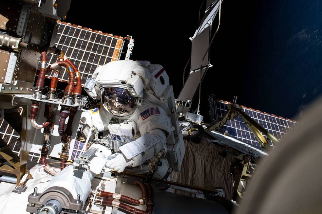 NASA spacewalker Kayla Barron installs a solar array modification kit