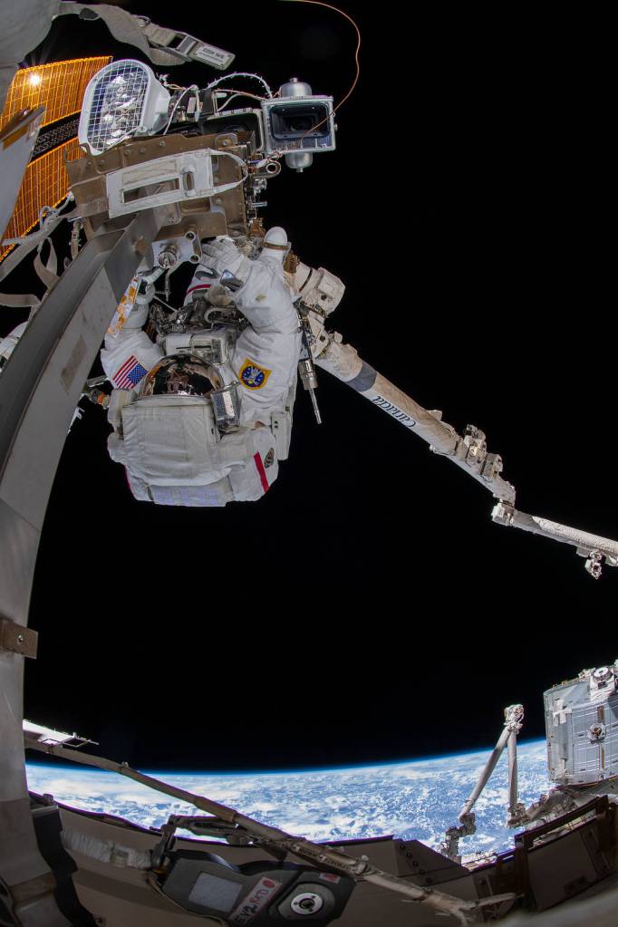 Astronaut Raja Chari is pictured attached to the Canadarm2