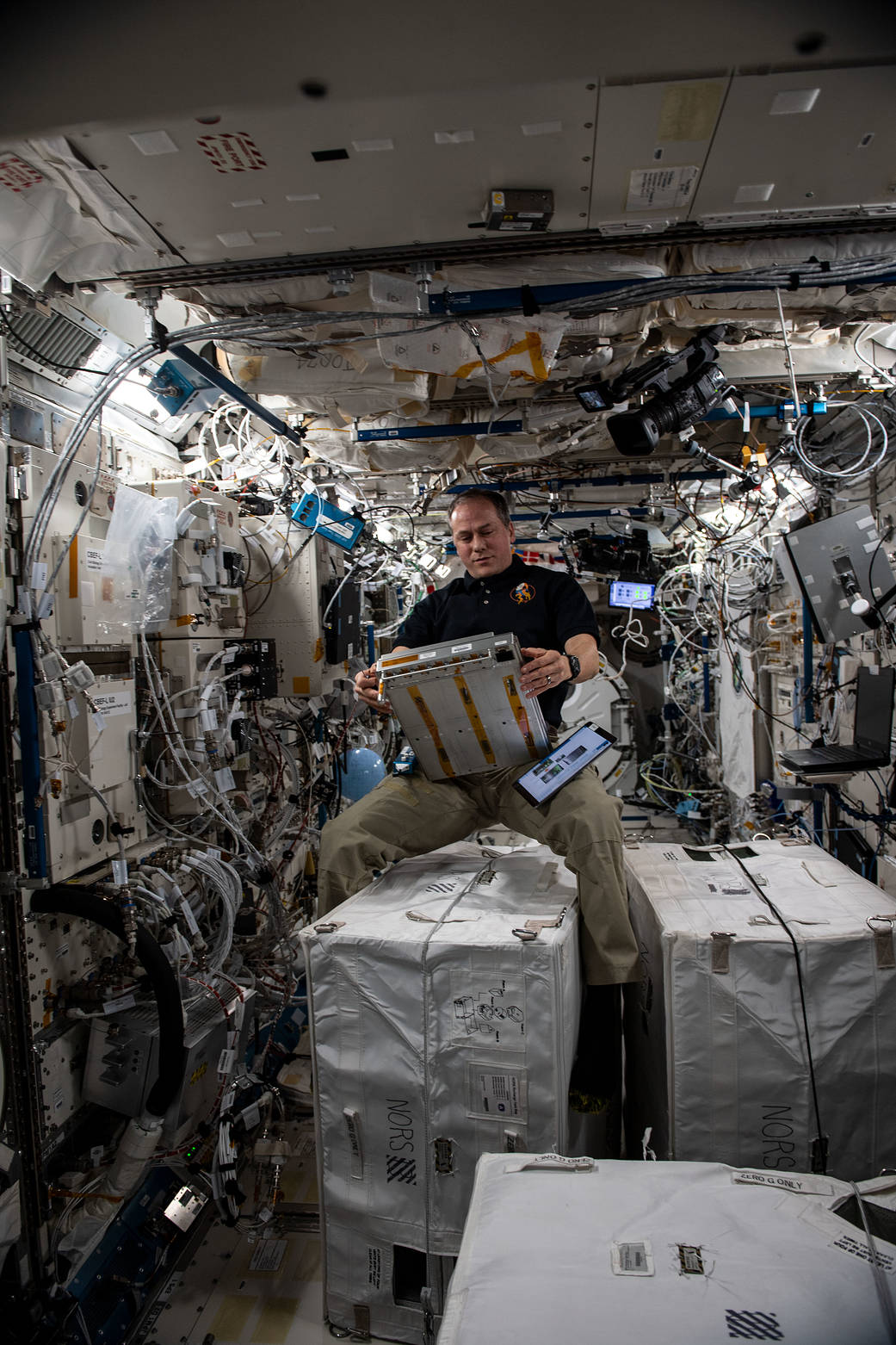 Astronaut Tom Marshburn services components on a unique incubator
