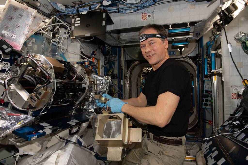 Astronaut Thomas Marshburn configures a combustion experiment