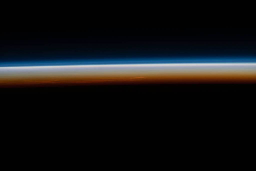 The last rays of an orbital sunset illuminate Earth’s horizon
