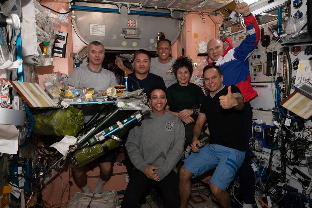 The Expedition 67 crew pose together for a dinner portrait