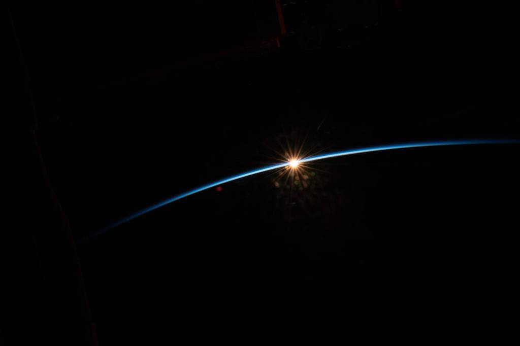The sun peeks above the Earth’s horizon