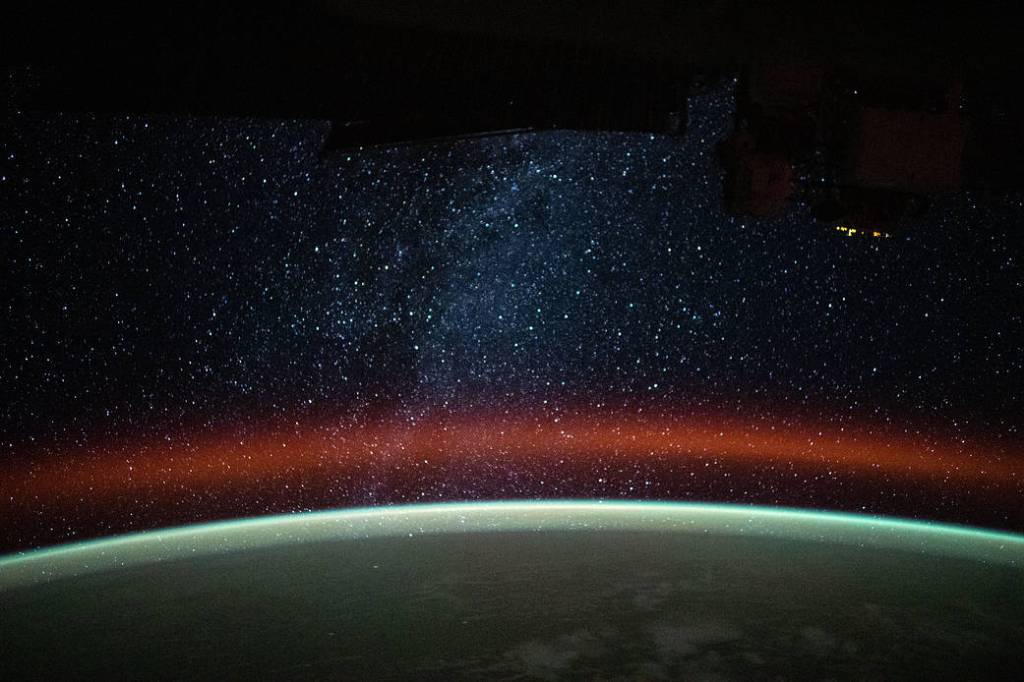 The Milky Way is pictured above Earth’s atmospheric glow