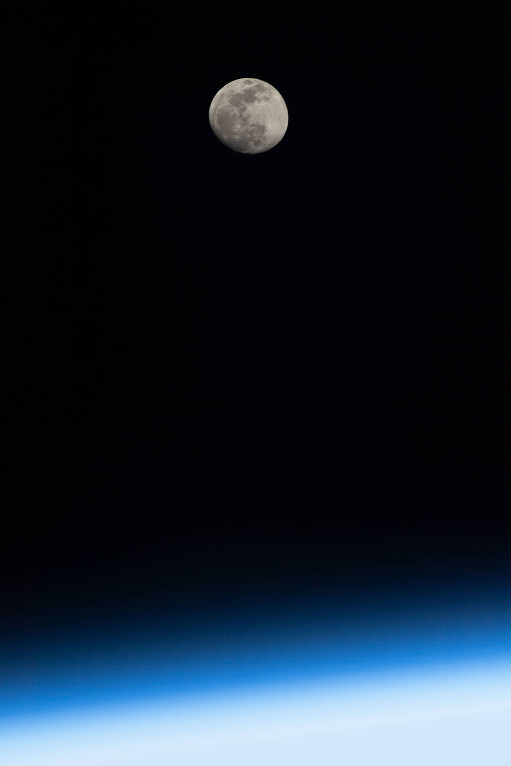 The waxing gibbous Moon above Earth's horizon