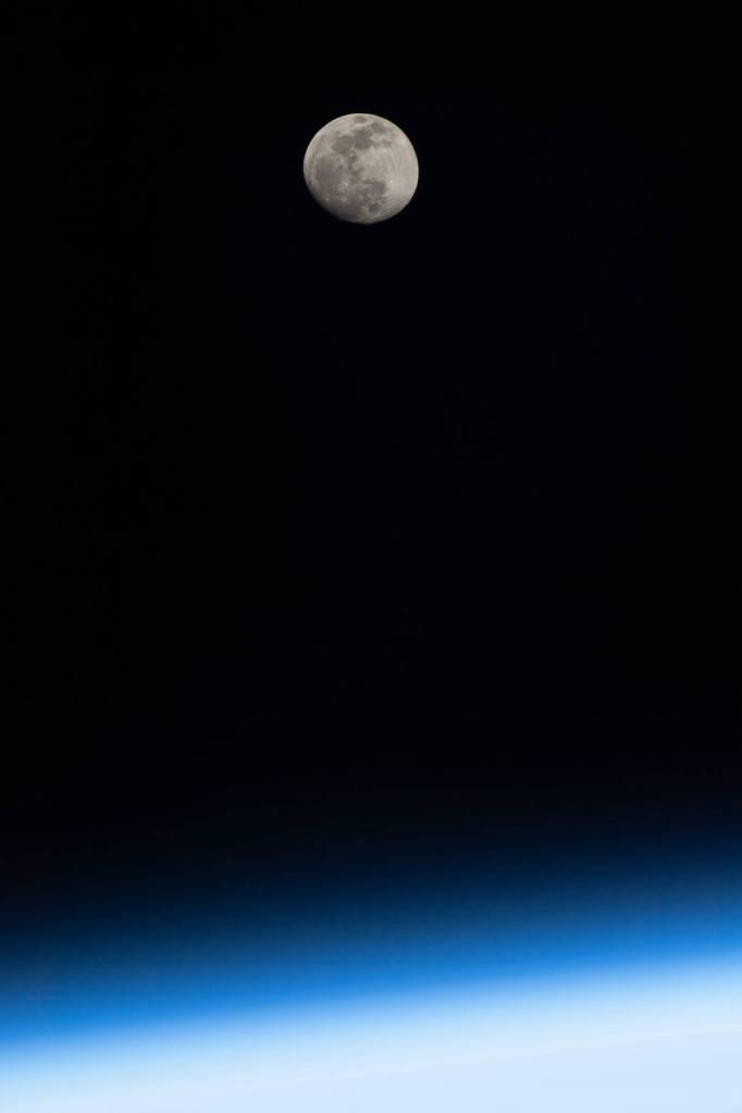 The waxing gibbous Moon above Earth’s horizon