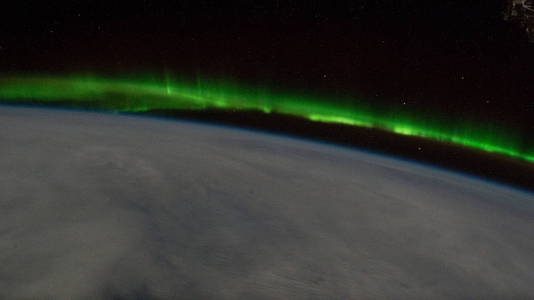 An aurora streams above the south Pacific