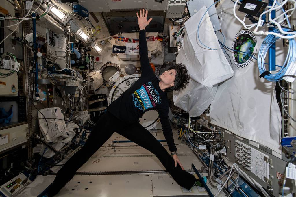 Astronaut Samantha Cristoforetti exercises and practices yoga maneuvers