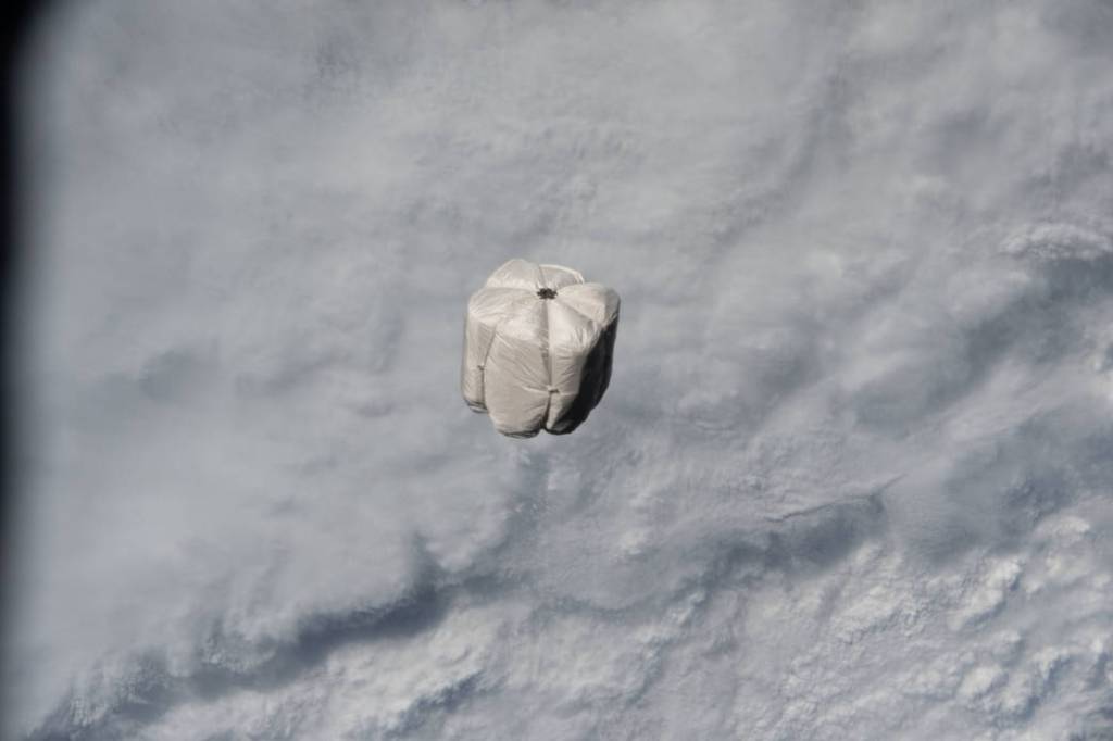A trash container is pictured on a trajectory away from the station