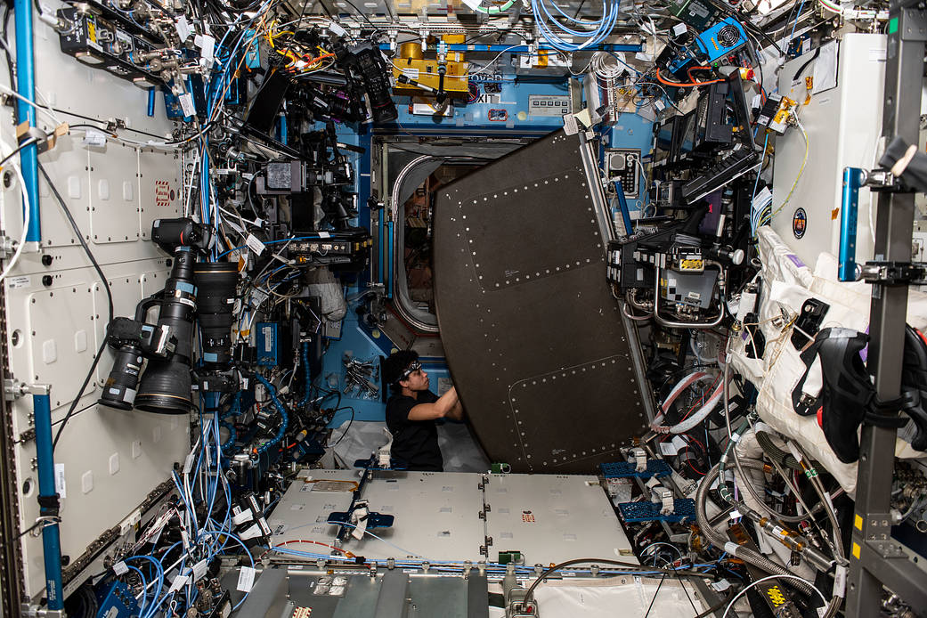 Astronaut Jessica Watkins replaces components on a life support device