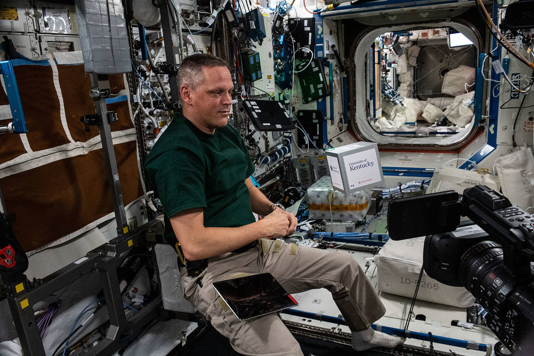 Astronaut Bob Hines activates a CubeLab Satellite