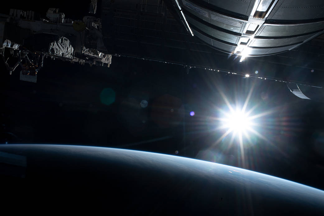 The sun illuminates Earth's limb above the Pacific Ocean