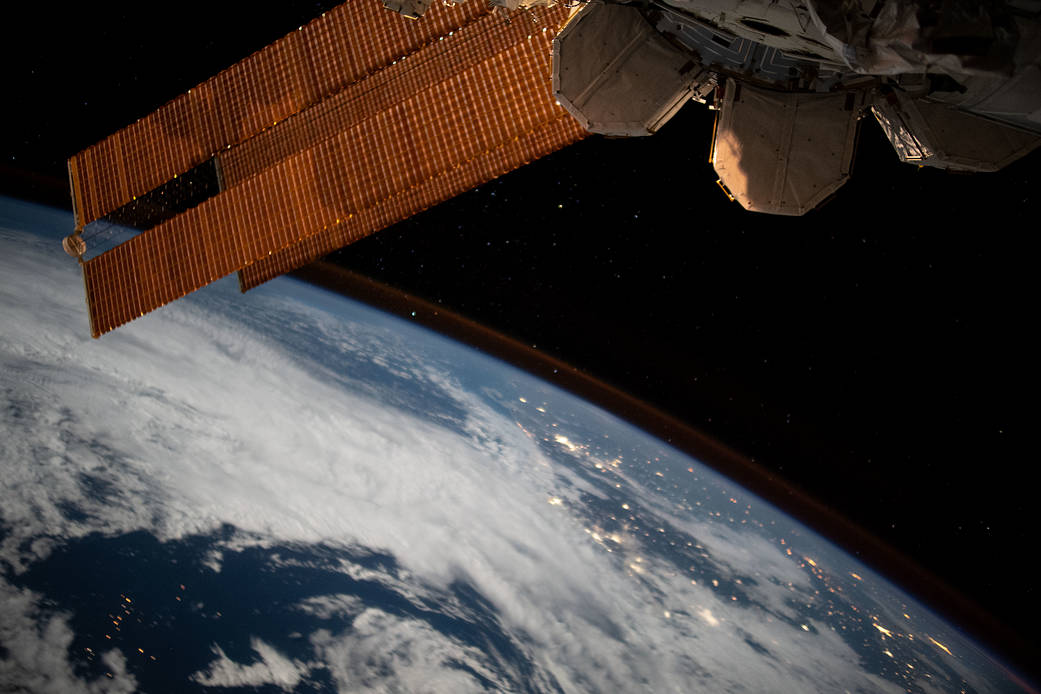 The city lights of Brazil sparkle underneath cloudy skies