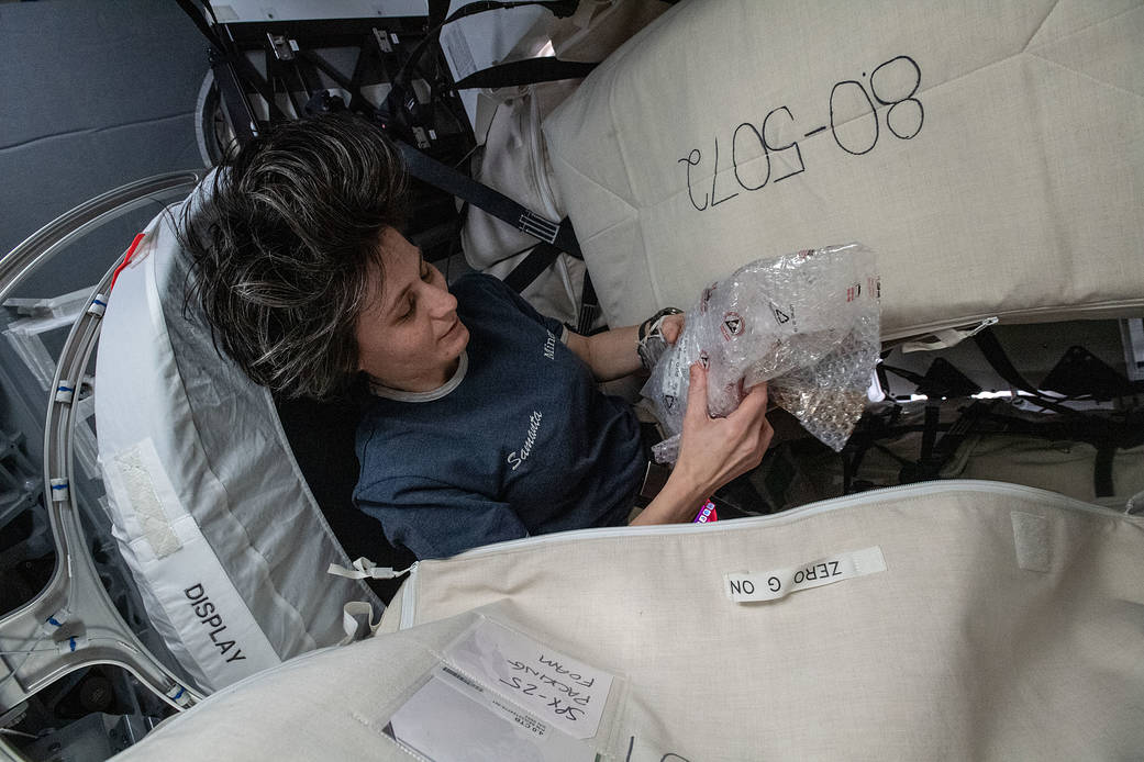 Astronaut Samantha Cristoforetti packs cargo inside the SpaceX Dragon