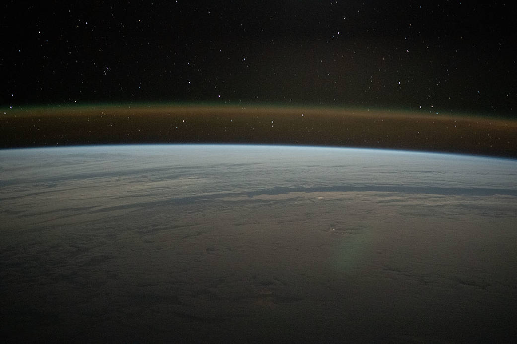 A cloud-covered Atlantic Ocean beneath a starry sky