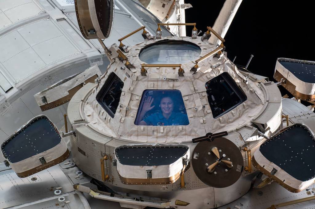 Astronaut Samantha Cristoforetti looks out from a window on the cupola