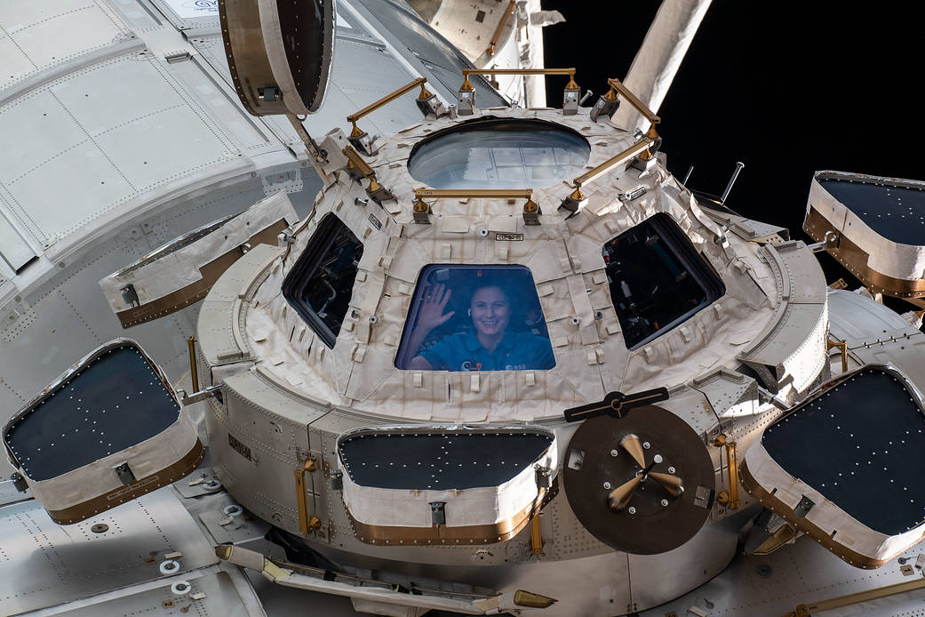 Astronaut Samantha Cristoforetti looks out from a window on the cupola