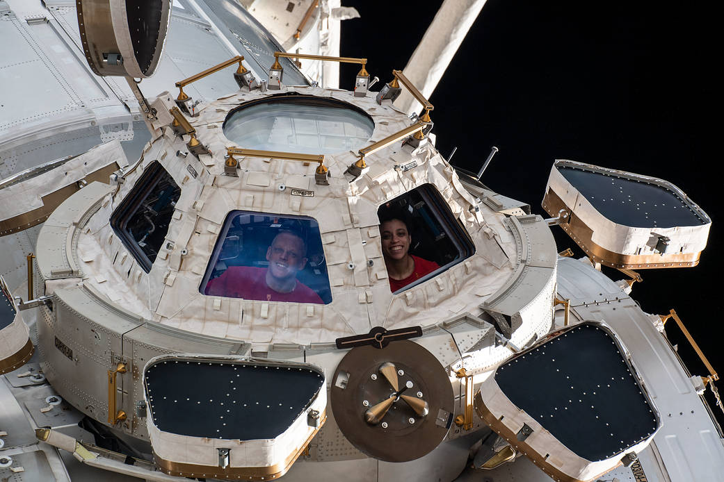 Expedition 67 Flight Engineers Bob Hines and Jessica Watkins, both from NASA, are pictured looking out from a window on the cupola, the International Space Station's "window to the world."