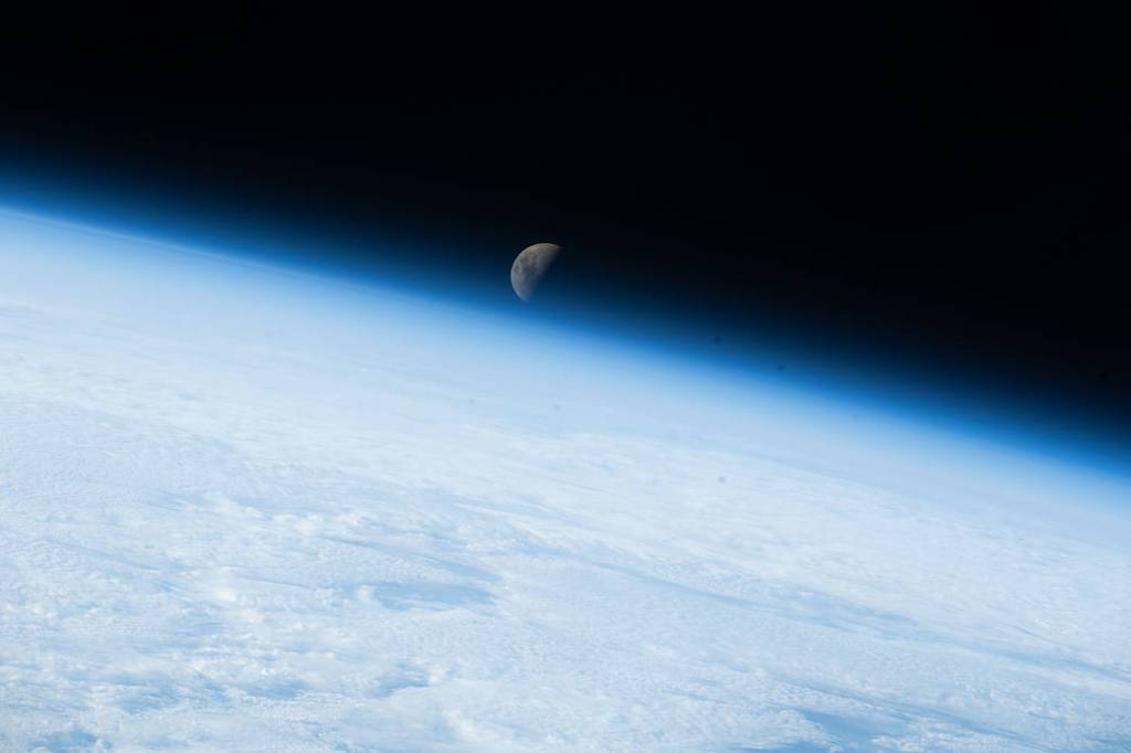 The first quarter Moon sets below Earth’s horizon