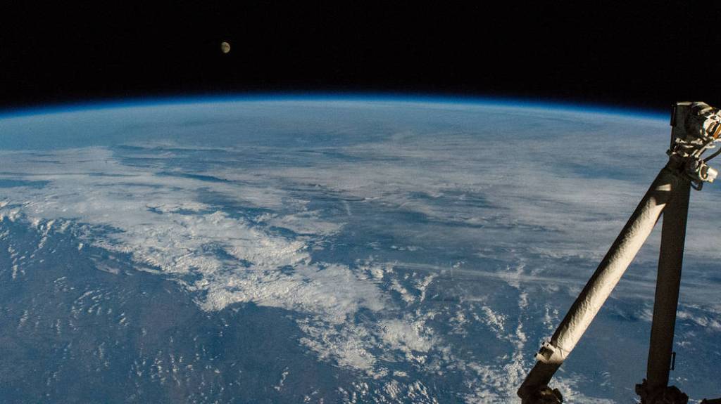 The waxing gibbous Moon above the Earth’s horizon