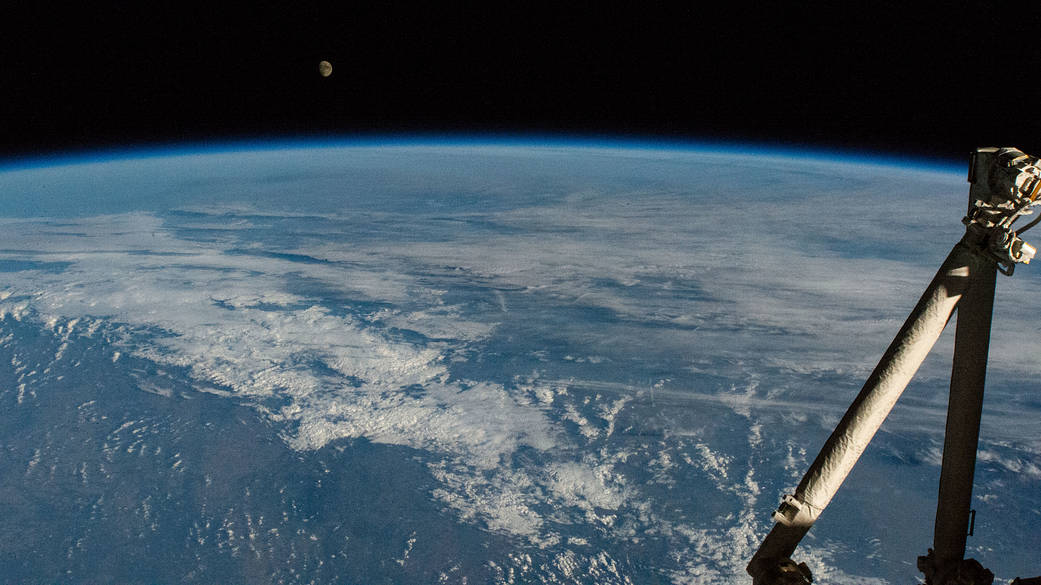 The waxing gibbous Moon above the Earth's horizon