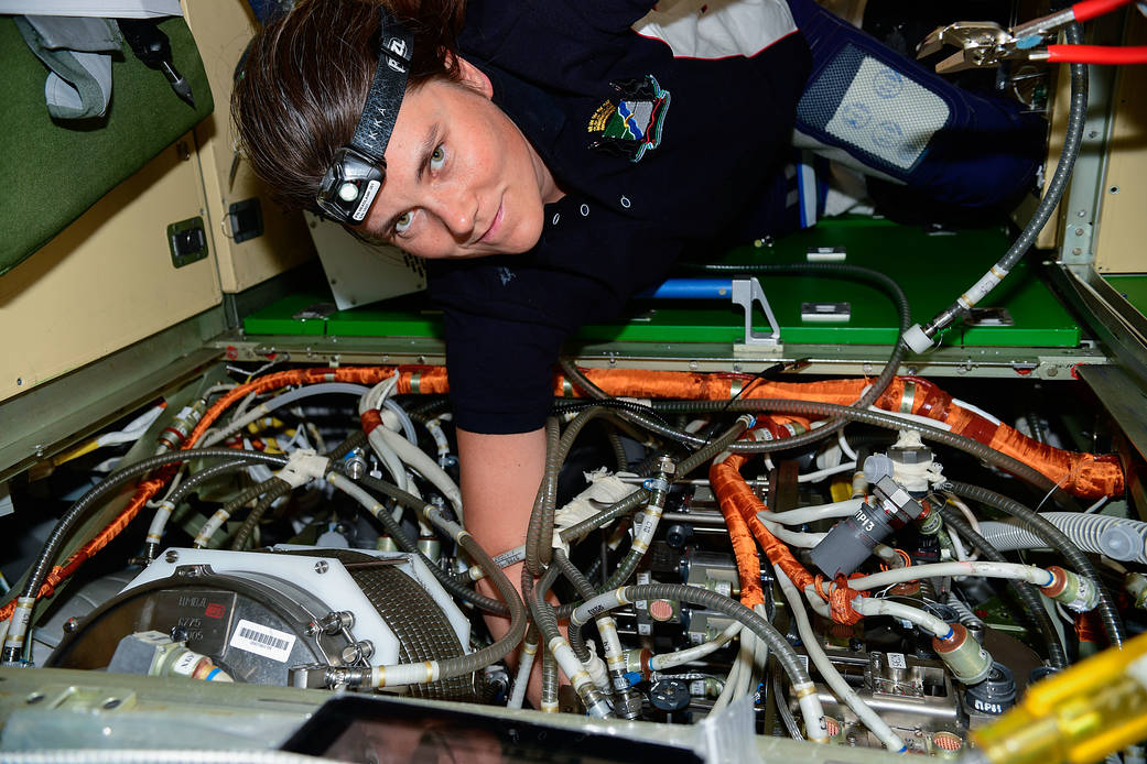 Cosmonaut Anna Kikina works on electronics gear