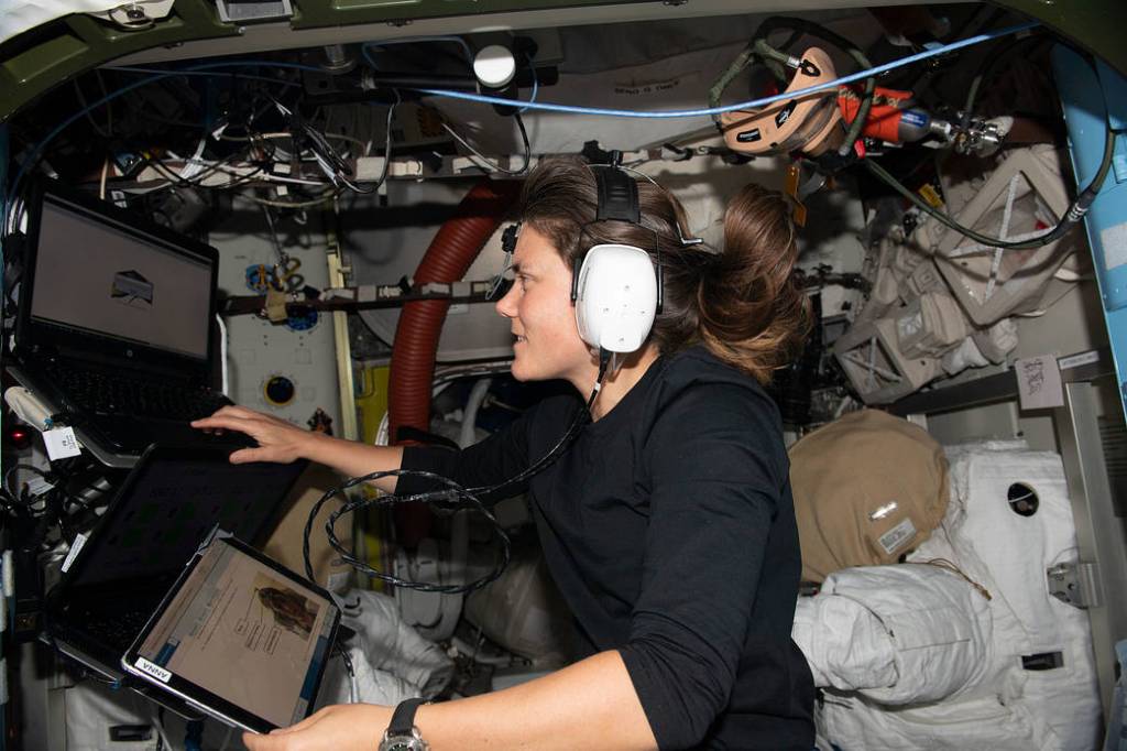 Cosmonaut Anna Kikina wears headphones for a hearing assessment