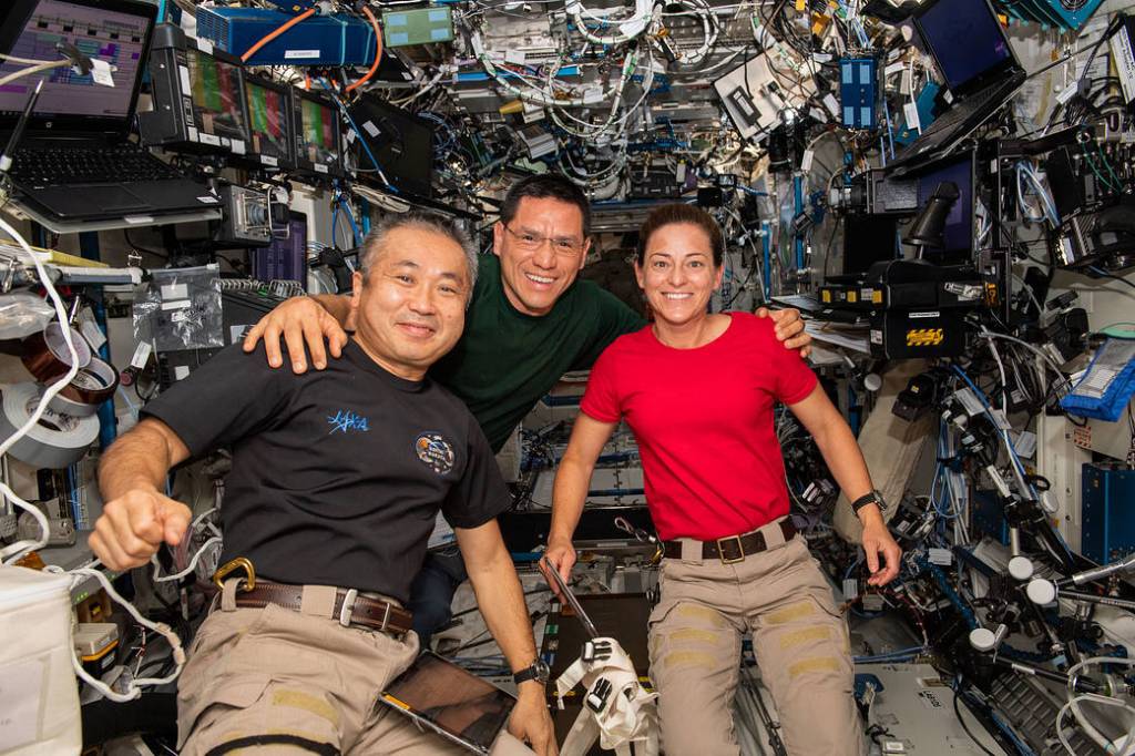 Three Expedition 68 Flight Engineers pose for a portrait